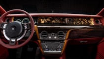 Wider show of cockpit showing full dash with marquetry and red leather interior