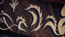 Close up shot of the in-laid dragon marquetry in-laid on the wooden dash of the Rolls Royce Phantom Dragon from a different angle