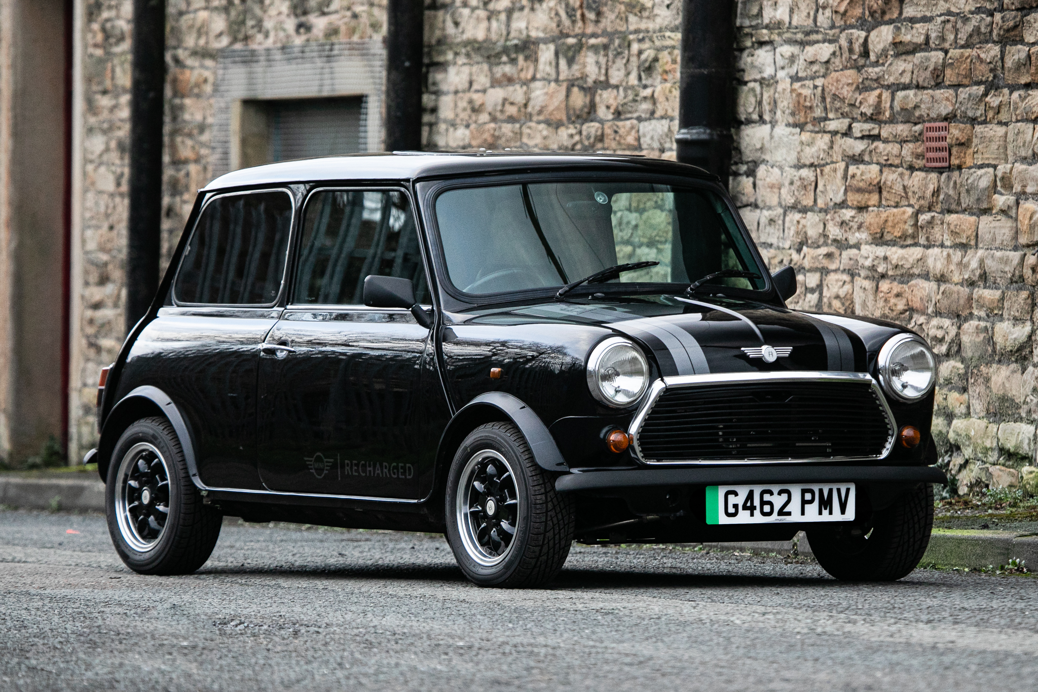 Parked shot of 1989 Rover Mini Thirty Electric with brick wall backdrop