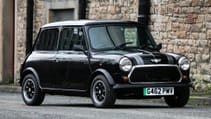 Parked shot of 1989 Rover Mini Thirty Electric with brick wall backdrop