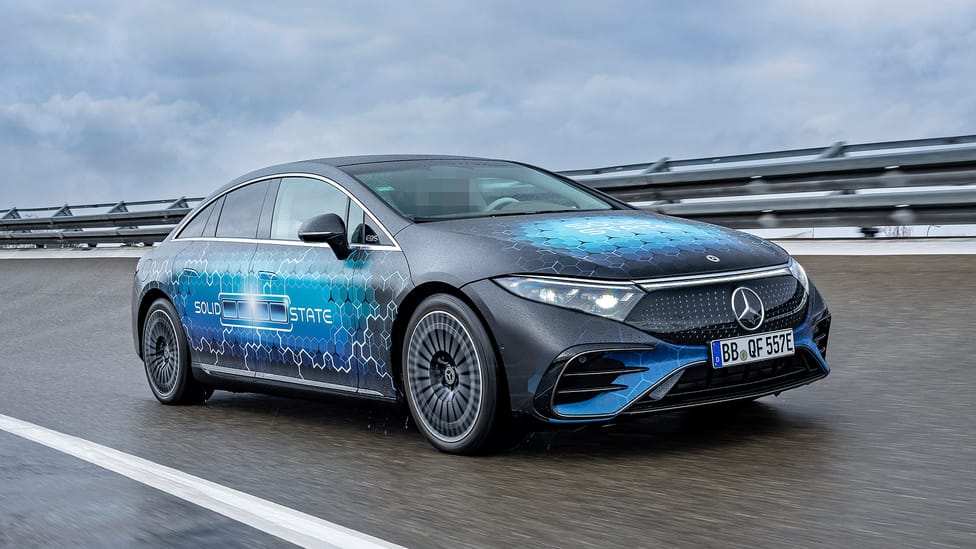 Driving shot of test EQS with solid-state batteries, blue decals on car