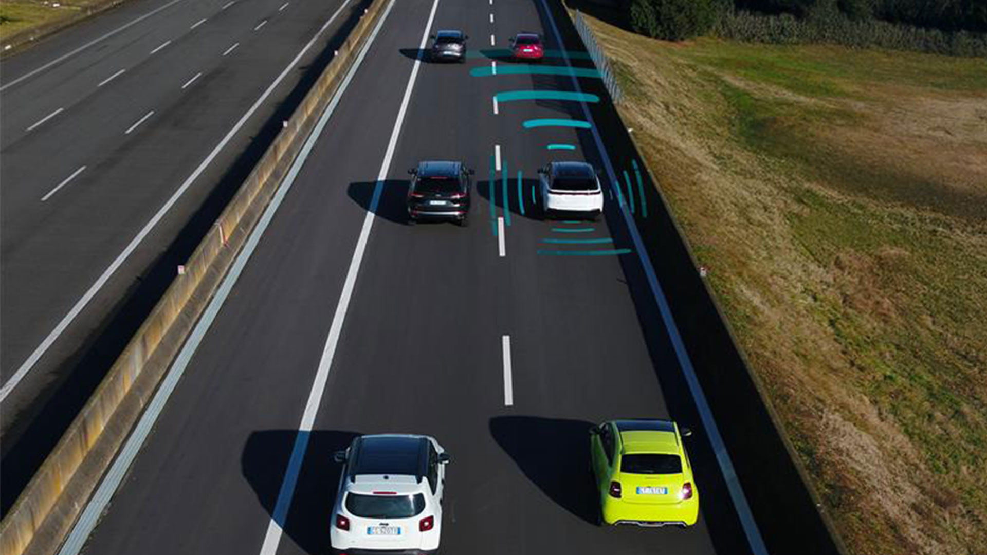 View of vehicles on a motorway, with graphics around one indicating the self-driving sensors