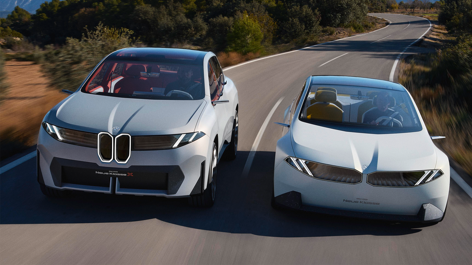 Driving shot of Neue Klasse SUV and 3-series-style saloon side-by-side on road