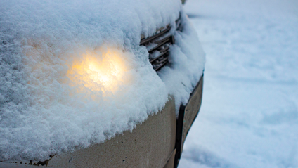 Headlights shining through snow