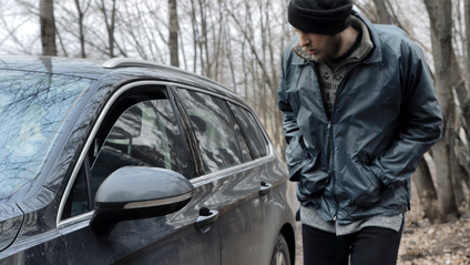 Passing opportunist looking into a car with a cracked window