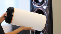 Female handling a hydrogen cartridge from Toyota's Woven City out of its holder