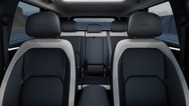 Interior shot of Kia EV5, looking back into the two front seats and rear