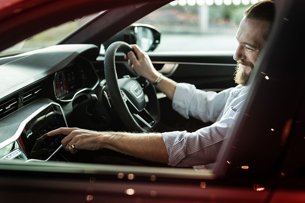 A man sitting in the driving seat of an Audi RS