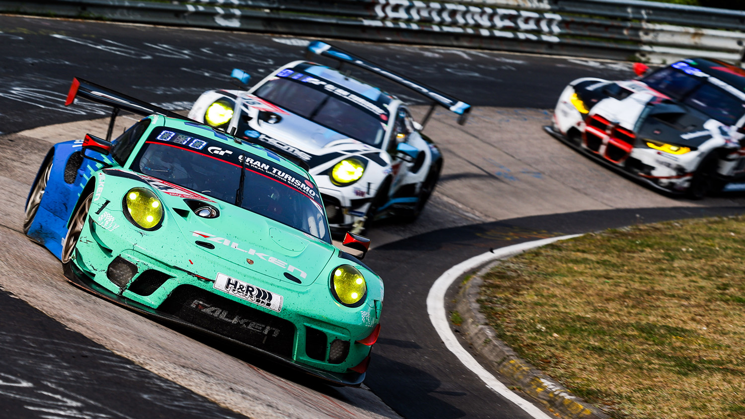 Cars racing at Karussell corner