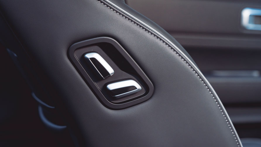 Close-up of the hybrid JAECOO 7 seat's sleek black leather upholstery with chrome seat adjustment levers, conveying luxury and modern design.