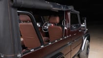 expedition-motor-company-rubellite-red-wolf-passenger-side-close-up-window-screen-night-time.jpg