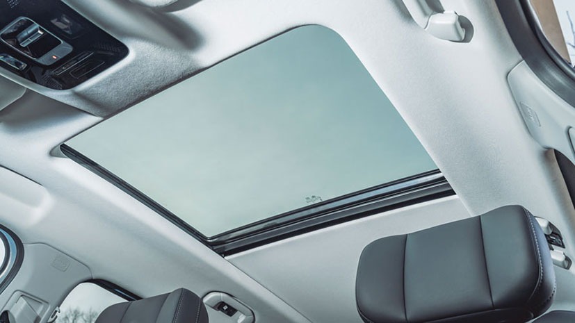 The interior of a hybrid JAECOO 7 SUV that features a large panoramic sunroof