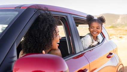 Two people smiling in a car