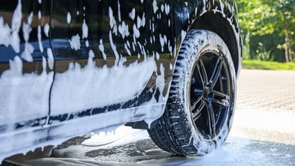 A car covered in soap suds foam 