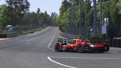A red and yellow race car #51 on a track, with trees in the background.