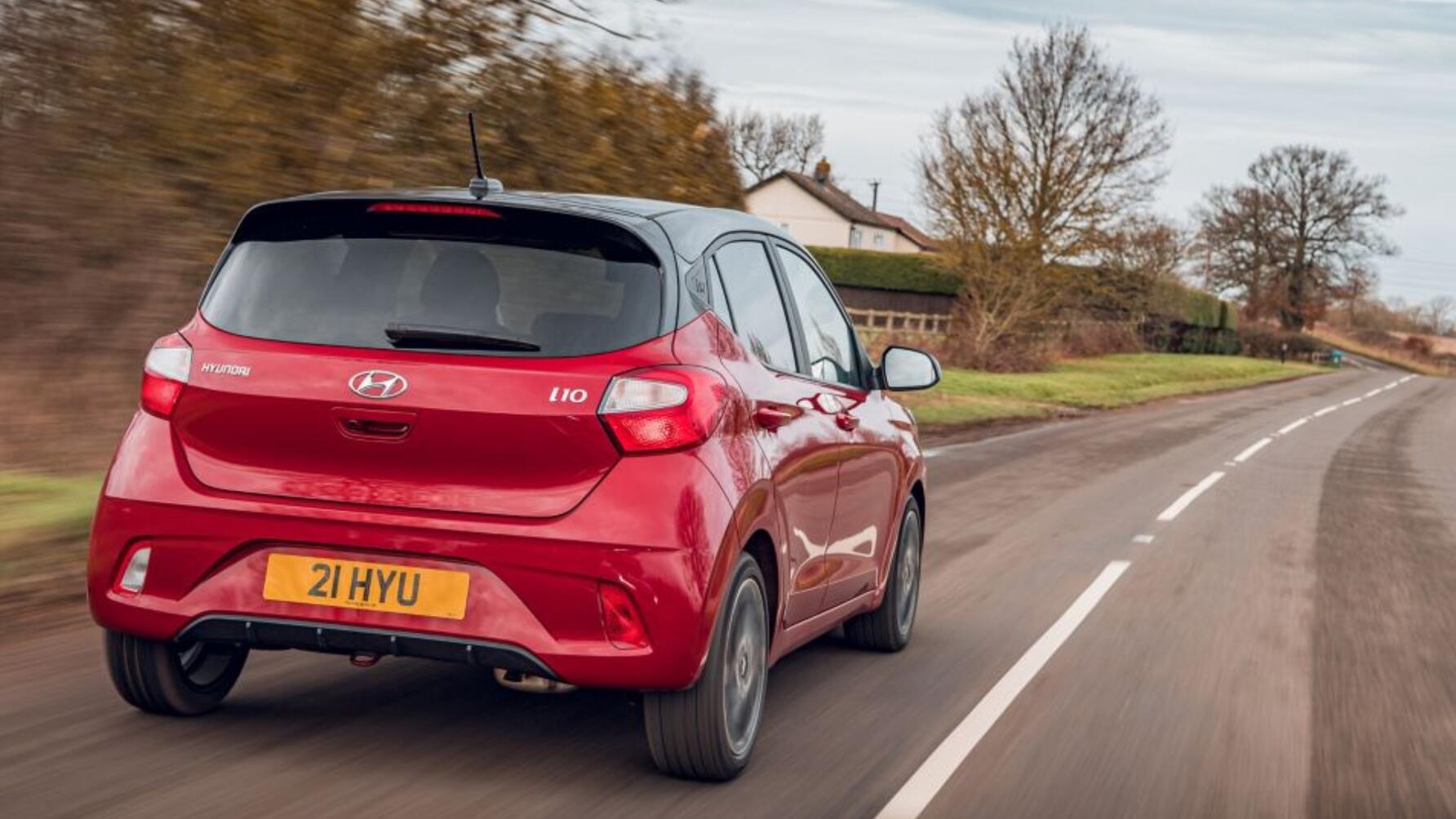 Driving shot of red Hyundai i10 from rear driver's side