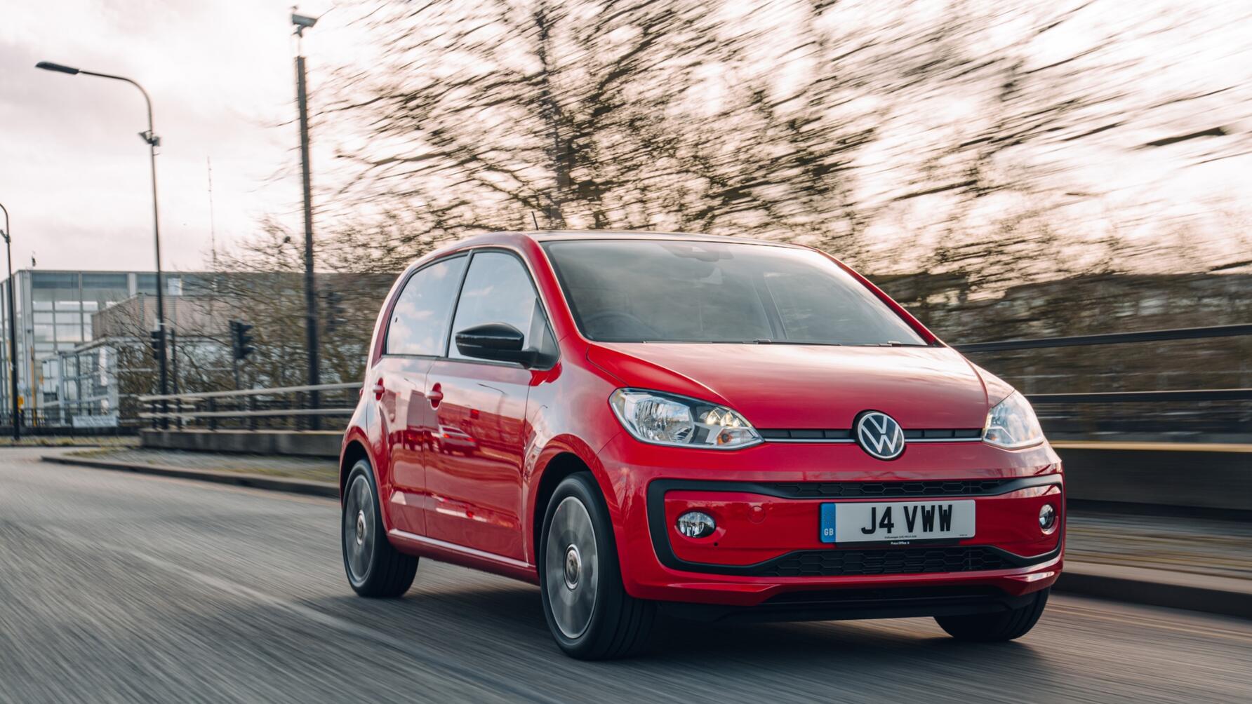 Driving shot of red VW Up from driver front