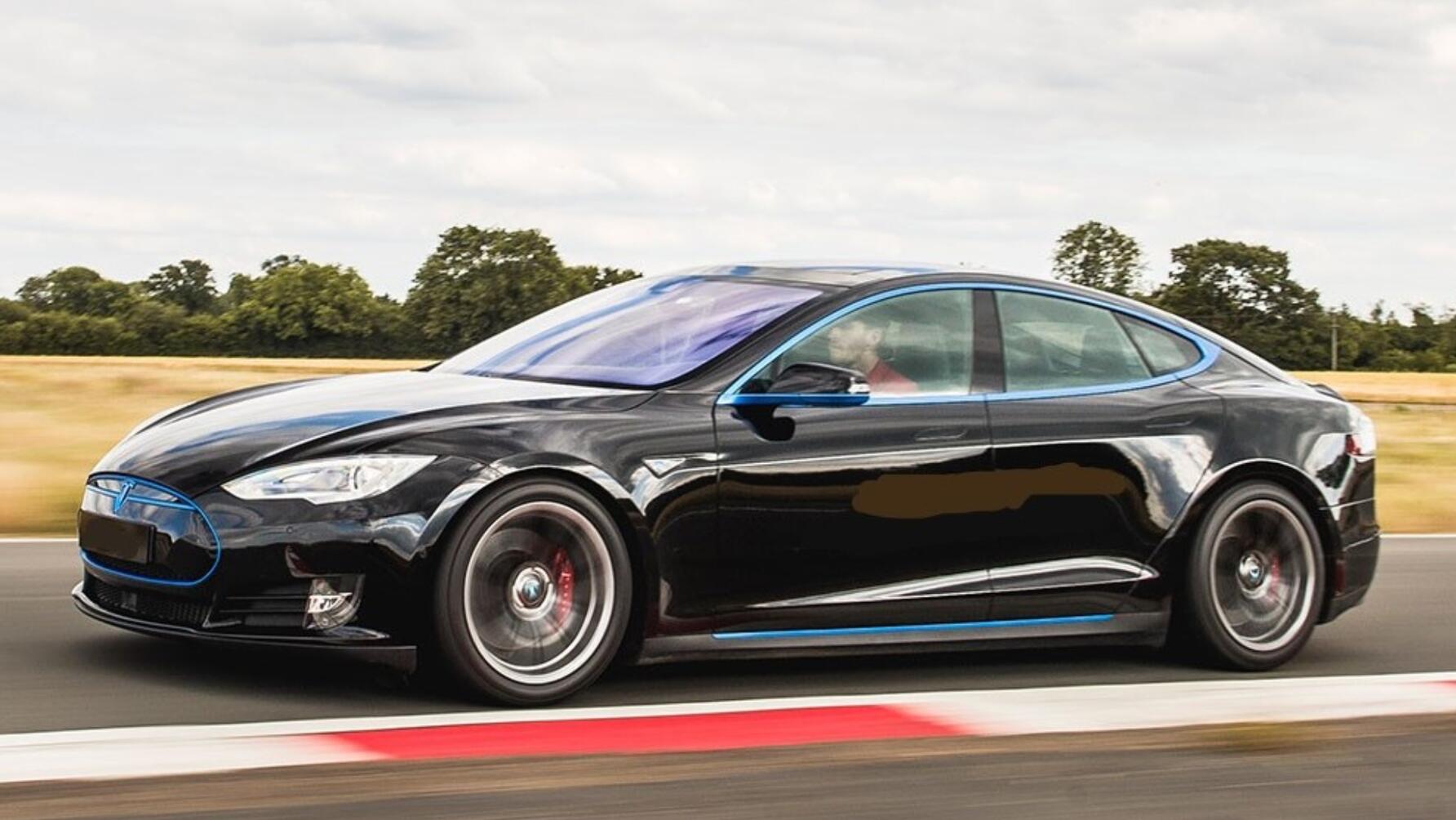 Track day driving shot of a black Tesla Model S